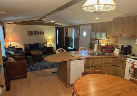 View of living room from kitchen. Kitchen table seats 6 and extension if needed.