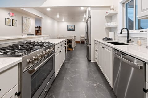 Huge propane oven grill with a huge granite kitchen island and fireplace!