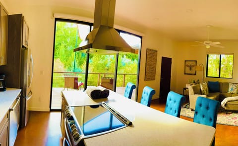 Floor to ceiling windows looking out to open space full of wildlife. 