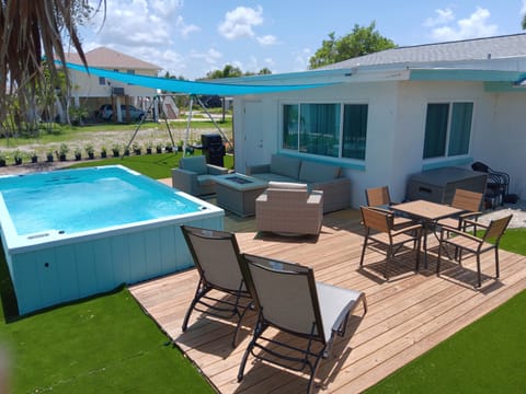Back yard to relax in and have fun.  Oversized, partially in ground, swim spa.