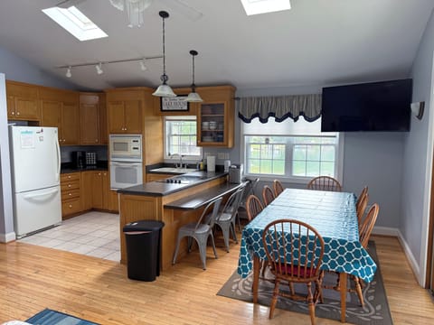 Kitchen with adjacent eating area and table for 8