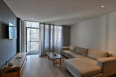 Two Bedroom Apartment | Living area | 32-inch flat-screen TV with satellite channels, TV