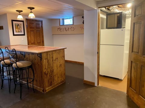 Bar area with adjacent refrigerator and wine chiller