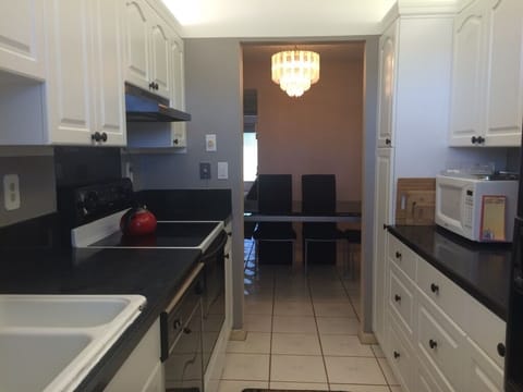 Updated bright kitchen, complete set of cookware, multiple small appliances.