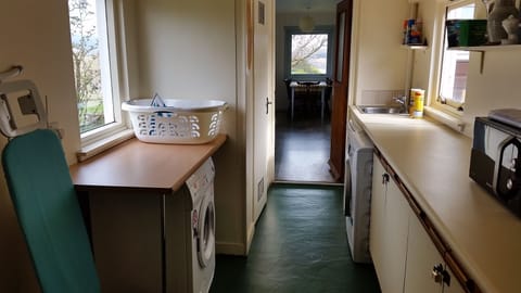 Utility room. Drier(left). Washing machine, dishwasher and microwave (right)
