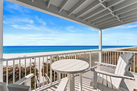 The balcony provides a breathtaking view of the Emerald Coast and the Gulf of America, offering a serene escape.