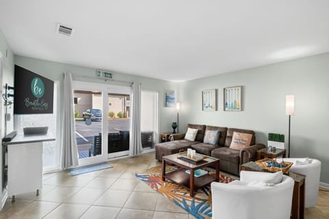 Welcome to Chateau LeMar. A pet friendly property. View of living room from the dining room and kitchen. Walk out to patio. Comfortable sofa with lounger at one end for a quick snooze.