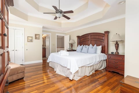 Bright coastal bedroom featuring a king bed and smart TV and ensuite bath with natural light