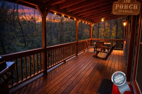 Unwind on the porch as the sun sets over the North Georgia mountains—string lights glowing, swing swaying, and the forest all to yourself.