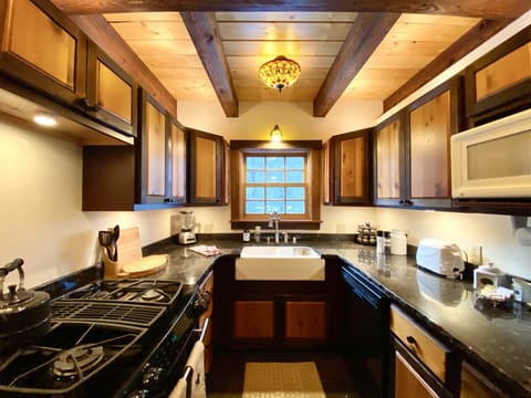 Small kitchen stocked w/ coffee, tea, sugar, olive oil, spices, napkins, & more!