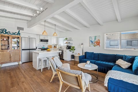 Living room/kitchen/dining open to balcony with ocean view over couch / balcony