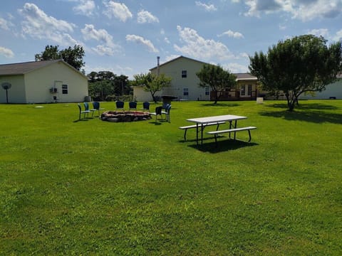 EXTERIOR: The shared outdoor bonfire ring and picnic table at the property.