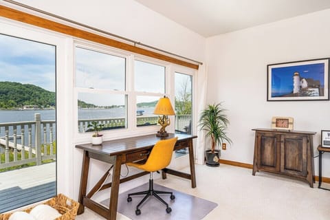 LIVING ROOM:  The home has a large and lovely living room with comfy furniture, a gas fireplace, a desk, a large television with free living streaming, and great views of Betsie Lake!