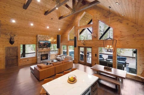 Living Room: Sunlit elegance with vaulted ceilings and nature views—perfect for gatherings!