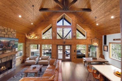 Luxury mountain living room with vaulted ceilings and forest views
