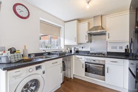 A fully equipped kitchen with fridge freezer, oven, stove, microwave, kettle, toaster, cookware, tableware, and utensils all provided