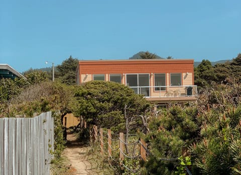 Head to the beach on the path in front of the house.