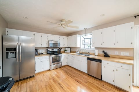 Fully stocked kitchen w/ pots & pans, dishware, Keurig, & regular coffee pot.