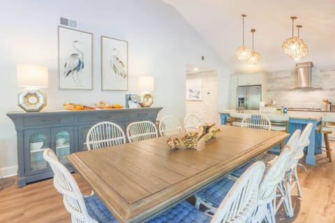 The dining table seats 10 and there are 4 stools at the kitchen's center island.