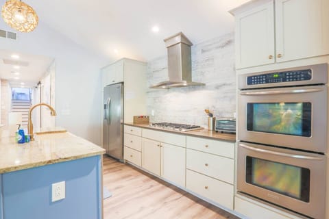 The kitchen features granite counter-tops, stainless steel appliances and shiplap backsplash.