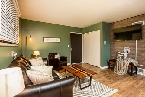 The living room is equipped with a full sized pull out couch and a 55" Smart TV