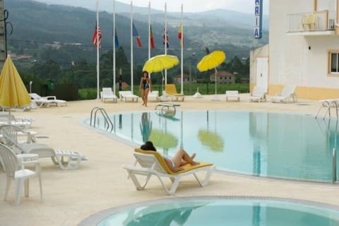 Seasonal outdoor pool, open 9:00 AM to 7:30 PM, pool umbrellas