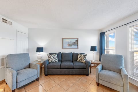 Unwind in your bright, comfortable living space with plush seating and coastal artwork creating the perfect retreat atmosphere.