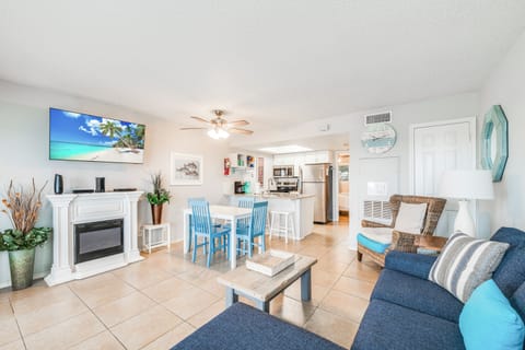 Unwind in this bright, coastal-themed living space where beach blues meet modern comfort for your perfect getaway.