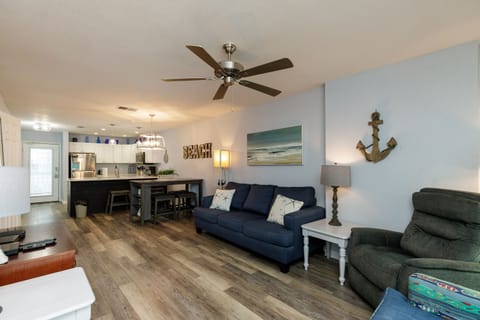 Relax in your spacious open-plan living space with coastal touches, comfortable seating, and a fully equipped kitchen perfect for beach getaways.
