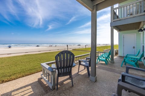 Step onto your private patio where colorful beach chairs await, offering front-row seats to endless ocean waves and soft sandy shores.