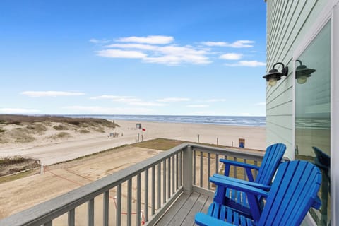 Sink into bright blue chairs on your private balcony and watch waves roll onto the pristine beach just steps away.