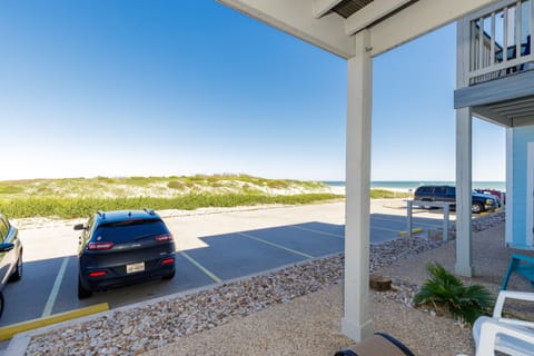 Beachfront property with convenient parking and stunning ocean views just steps from pristine sandy shores.