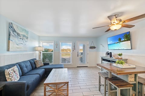Unwind in your coastal-inspired living space where beach vibes meet comfort—plush sectional seating and tropical touches create your perfect vacation retreat.