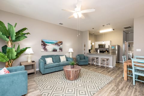 Relax in this beautifully styled open living space where coastal colors meet comfort, complete with modern kitchen and dining area.