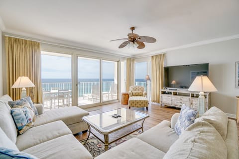 Relax in your spacious living room with breathtaking ocean views through floor-to-ceiling windows and direct balcony access.