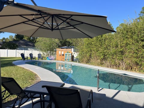 Relax under the umbrella by your private heated pool near St. Augustine.