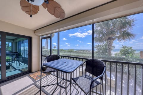 Screened in patio with table and 4 chairs, storage closet w/beach supplies.
