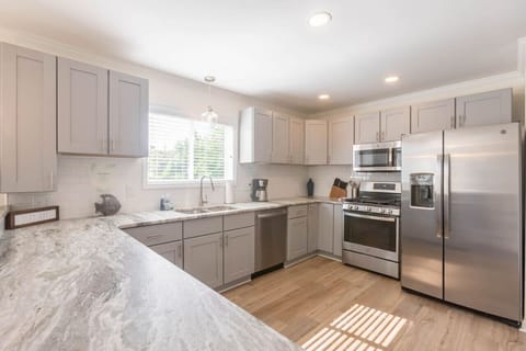 A large kitchen can be found on the main floor in the heart of the home. Enjoy a gas range, oven, full size refrigerator, microwave, dishwasher, and all the basics you need for cooking. We also provide dining ware for kids and a coffee pot.