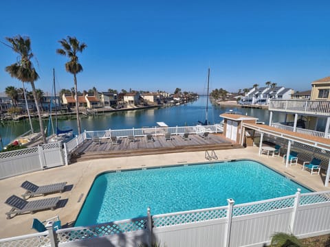 View from our patio overlooking our outside pool and wide canal to Gulf Bay.