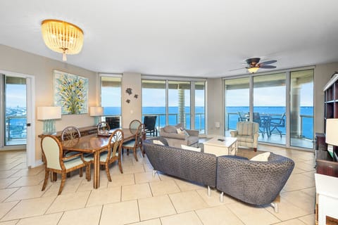 Step into your bright coastal retreat where gulf breezes meet elegant comfort. Relax in a spacious living area with stunning views through floor-to-ceiling windows. Your private balcony awaits.
