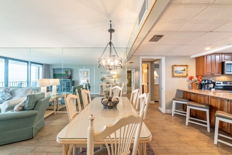 The dining table comfortably seats 8 with additional seating at the bar