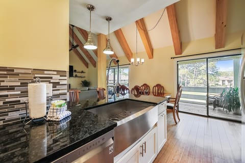 Kitchen flows into open views of the living room