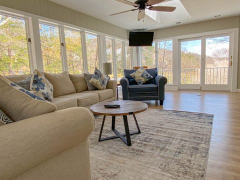 Windows all around Sunroom and Living Area off of Open Kitchen and Dining.