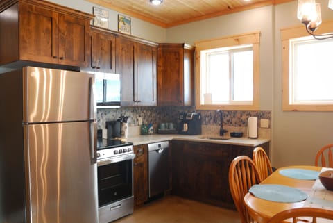 Kitchen with new stainless steel appliances.