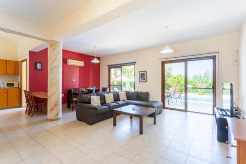 Open-plan living room with sofas, dining area, kitchen, A/C, WiFi internet, satellite TV, and terrace access