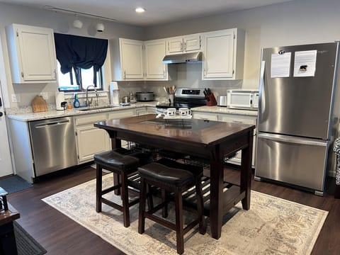 Spacious kitchen with island for prep and casual meals.
