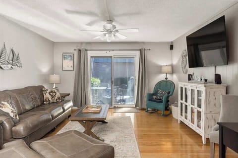 Cozy living room with leather seating and a sliding door to the patio.