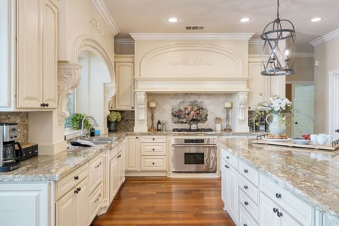 Chef's kitchen with a large island counter and modern appliances.