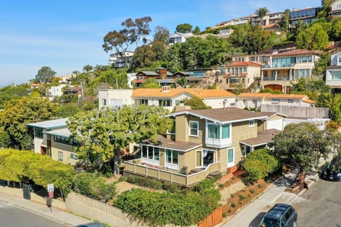 Charming Coastal Retreat with Lush Greenery and Serene Ocean and Hillside Views