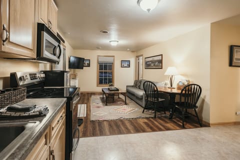 Cozy living room with couch, table, & RokuTV